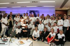 Large group of walkers posing for photo in studio at the end of the event
